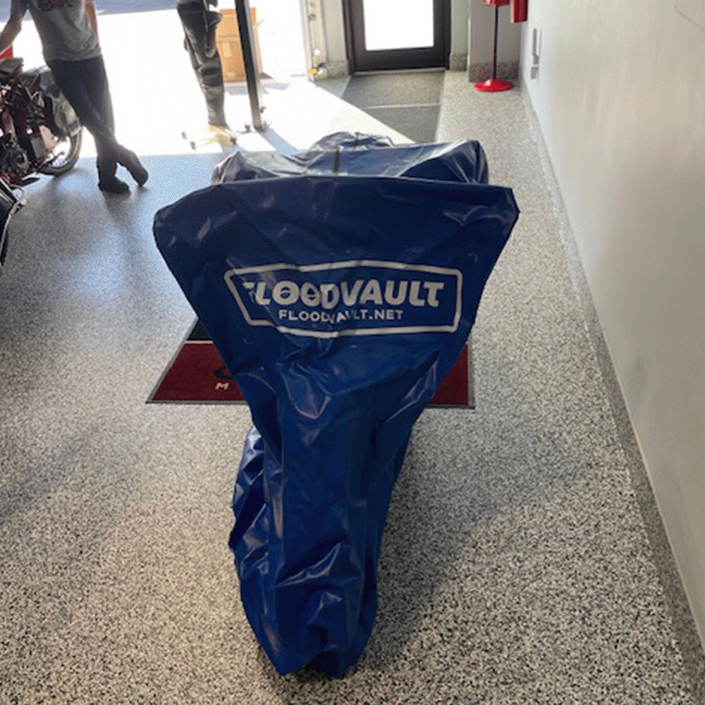 Motorcycle fully enclosed in a sealed blue FloodVault Moto vault.