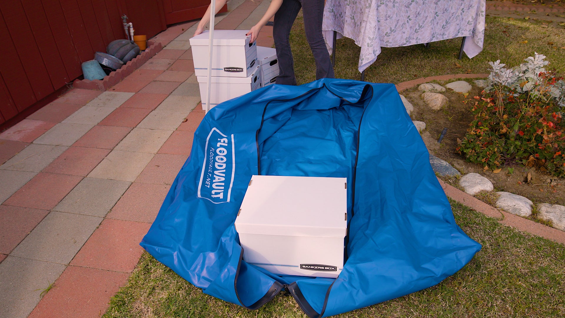 FloodVault Valuables opened on a walkway, a banker's box being loaded inside.